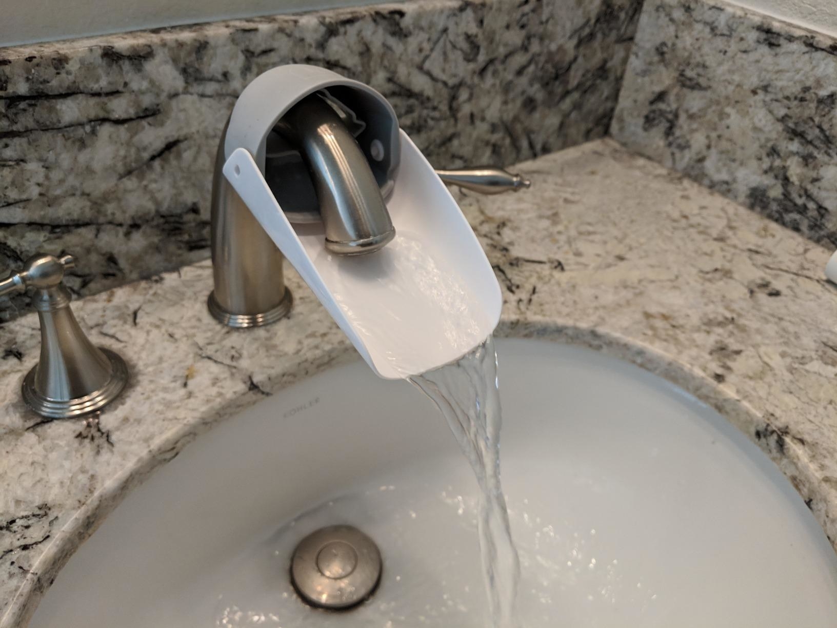 the faucet extender on a running faucet