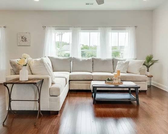 Reviewer photo of a living room with white sheer curtains on the windows