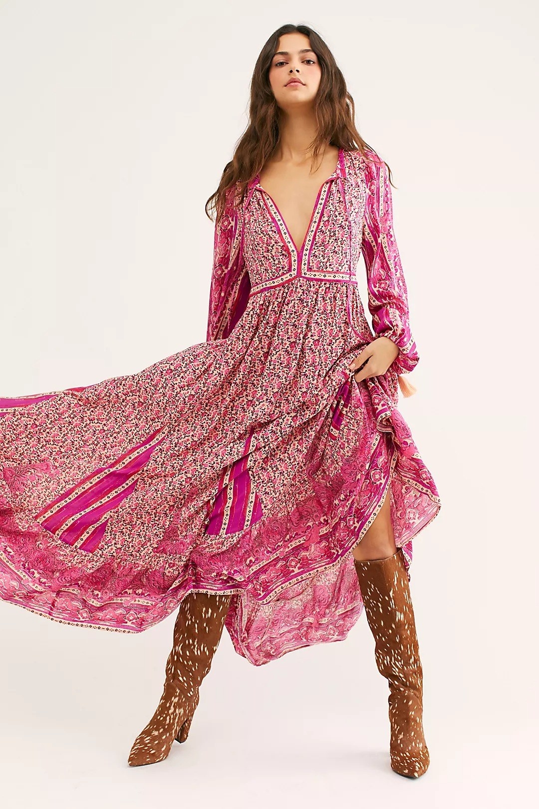 Model wearing printed hot pink maxi dress with deep V-neck