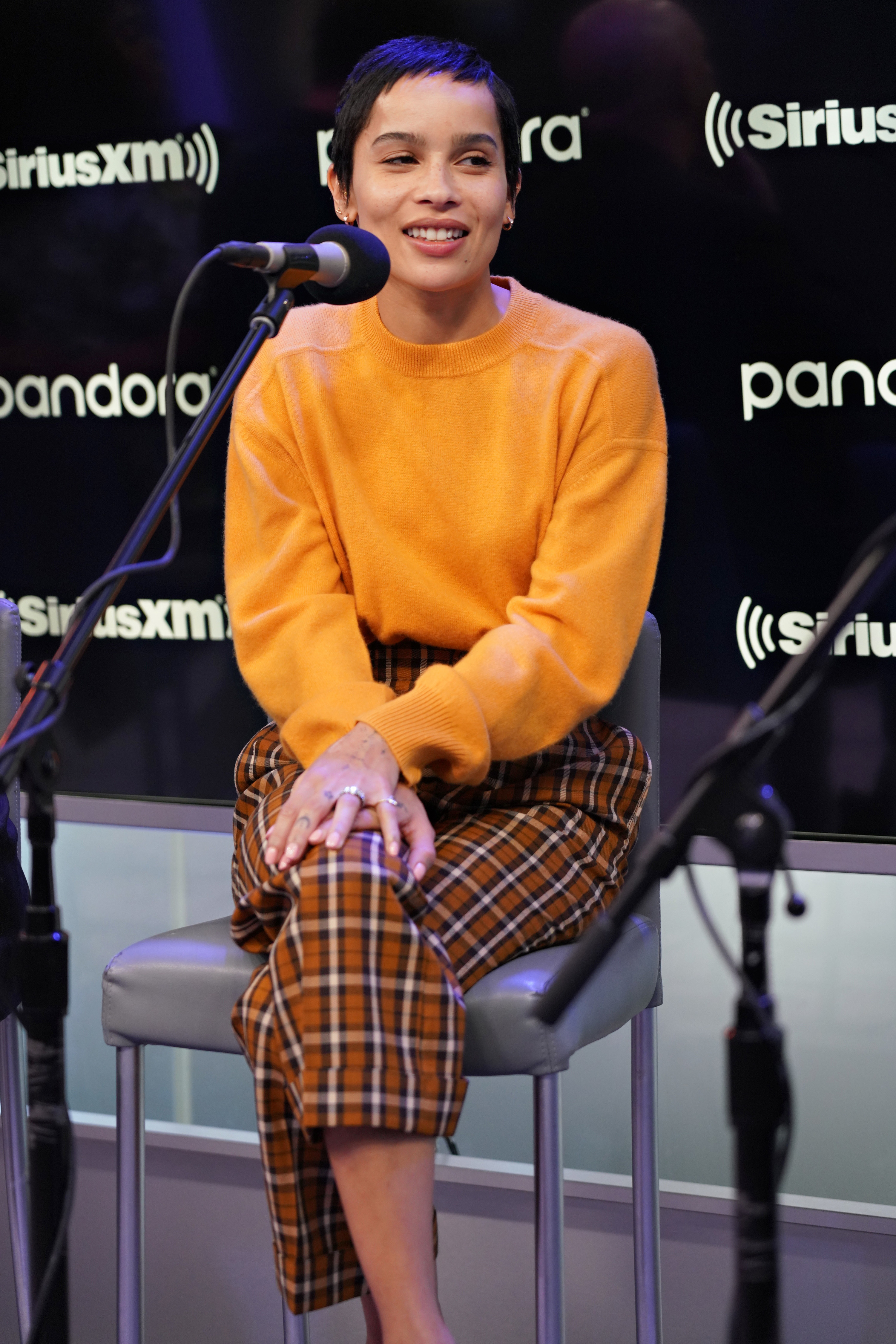 Zoë sitting in a tall chair during a radio interview