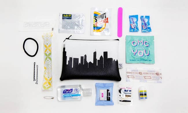 the black and white zip-top pouch surrounded by a makeup wipe, hand sanitizer, and more small provisions