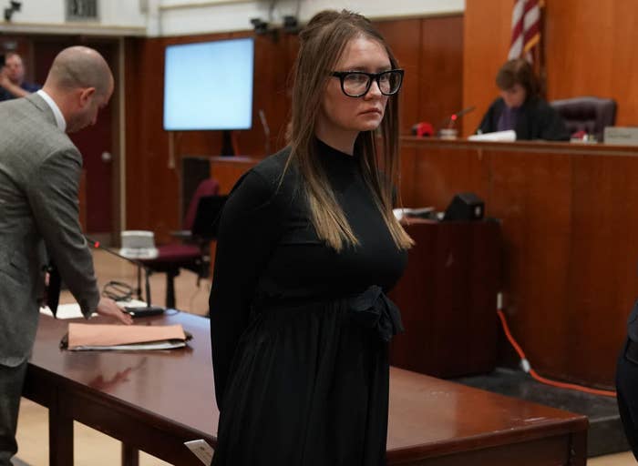 dressed in a long-sleeved babydoll dress, the real Anna is led out of the courtroom after sentencing