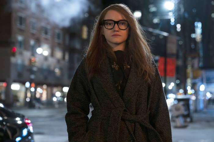 wrapped in a thick coat, Anna faces the cold New York City streets alone