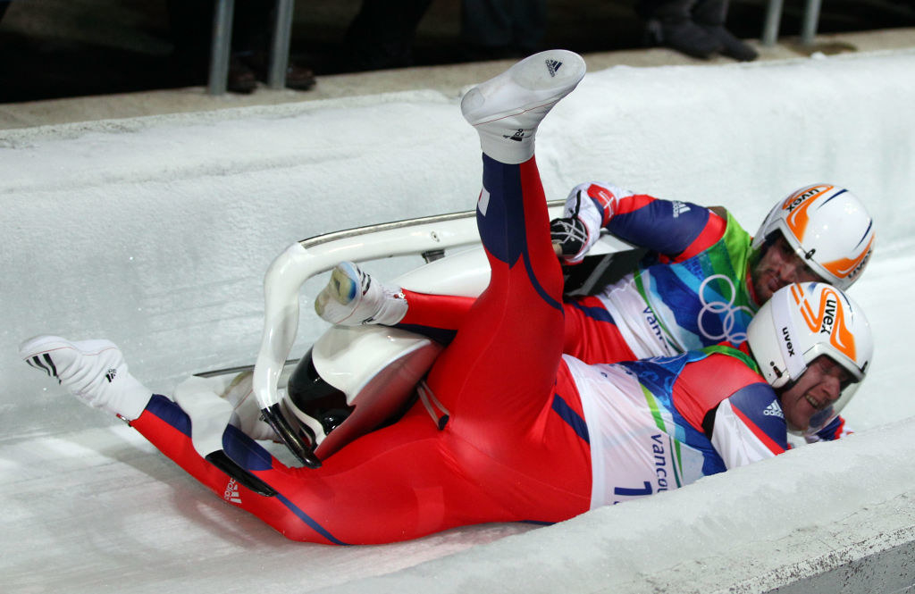 A team crashing and flipping sideways on the track