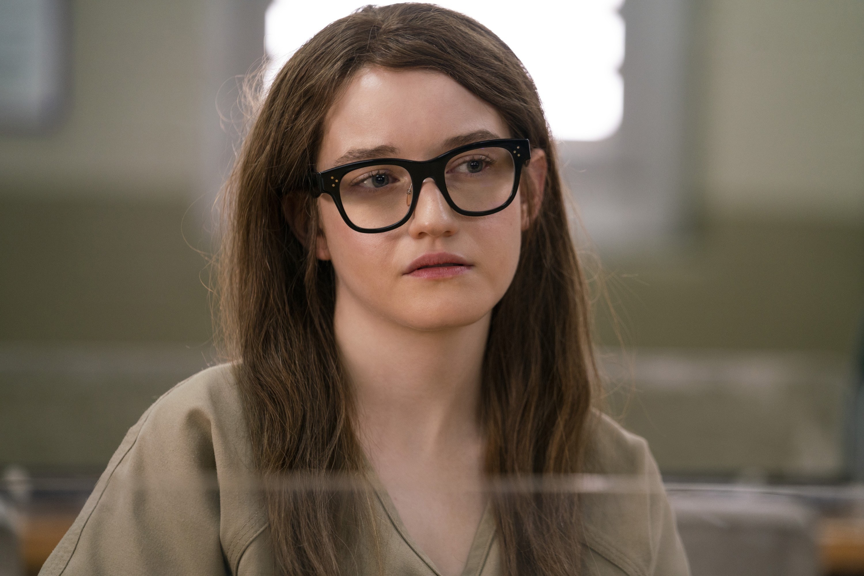 dressed in her prison uniform and thick glasses, Anna meets with Vivian in prison