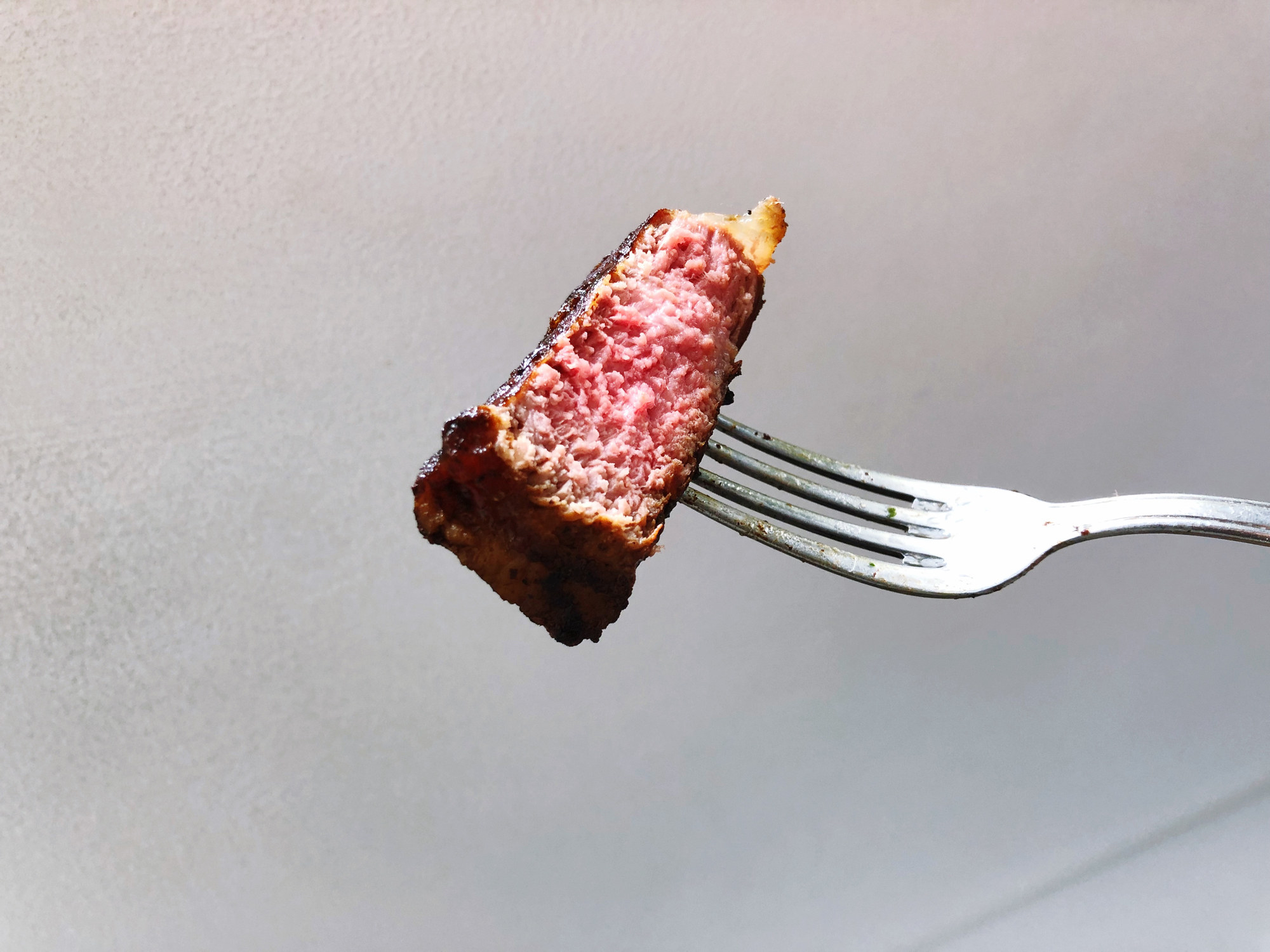 A piece of steak on a fork.