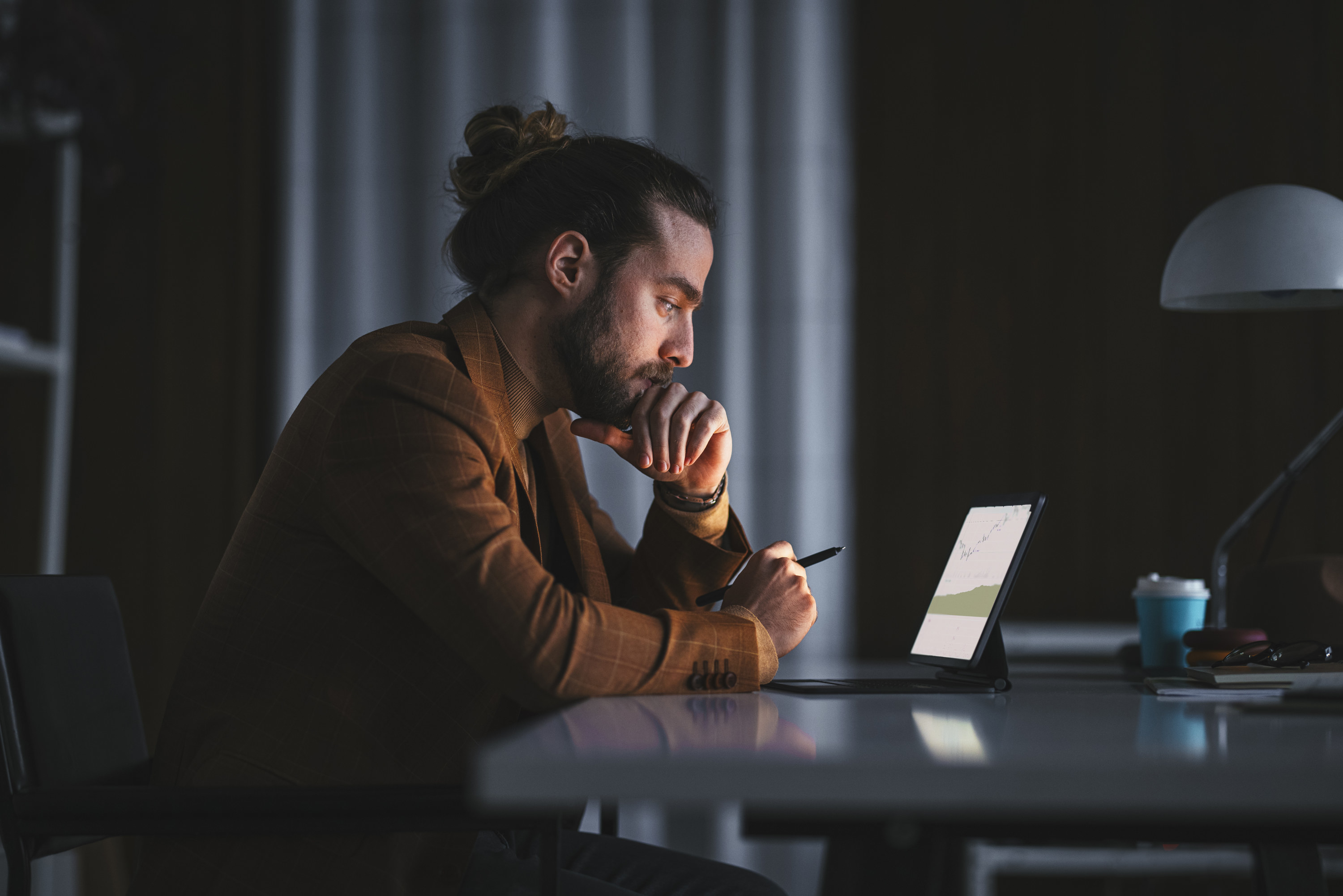 Man looks at computer in the night