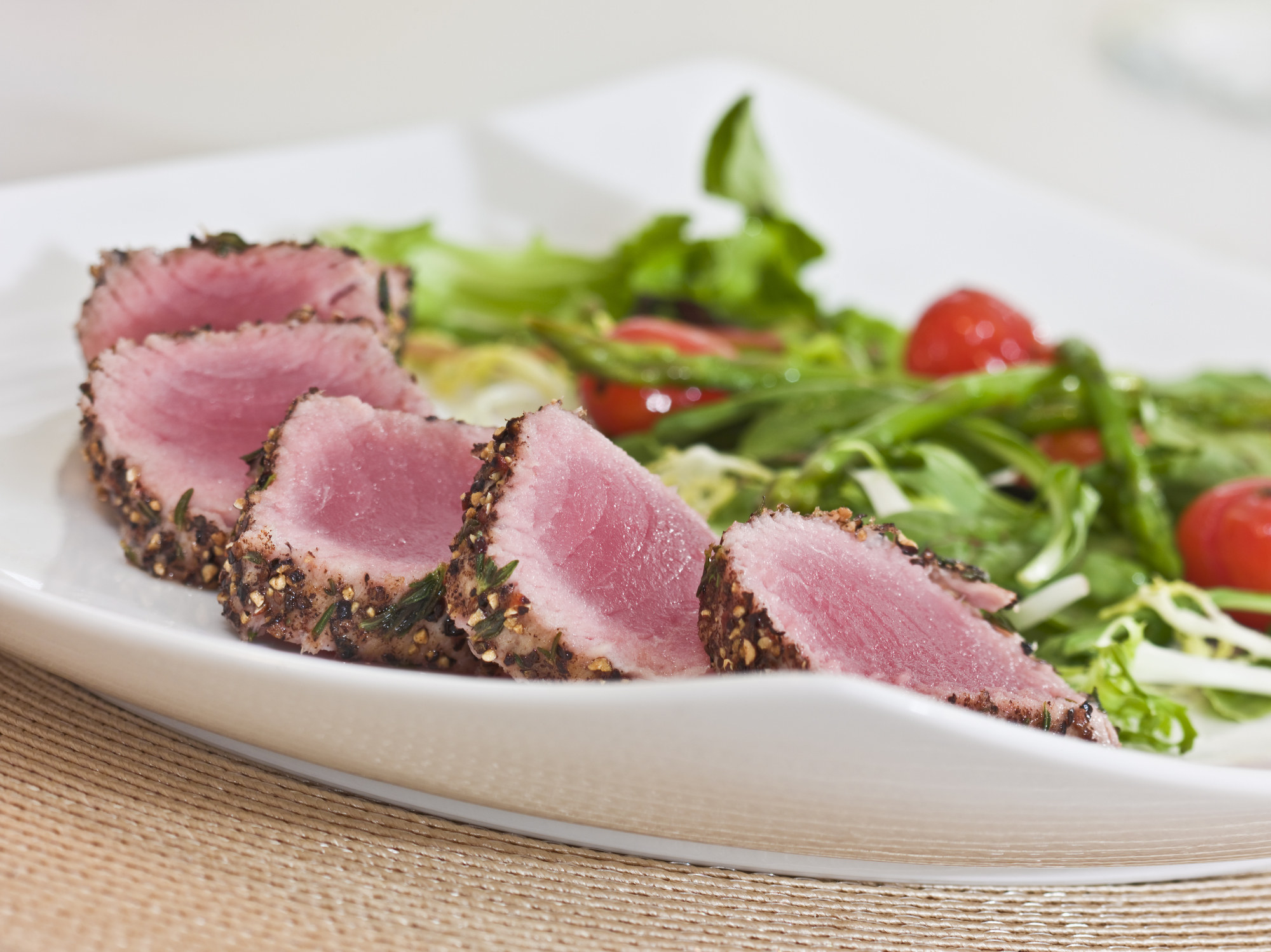 Seared tuna with sesame crust on salad