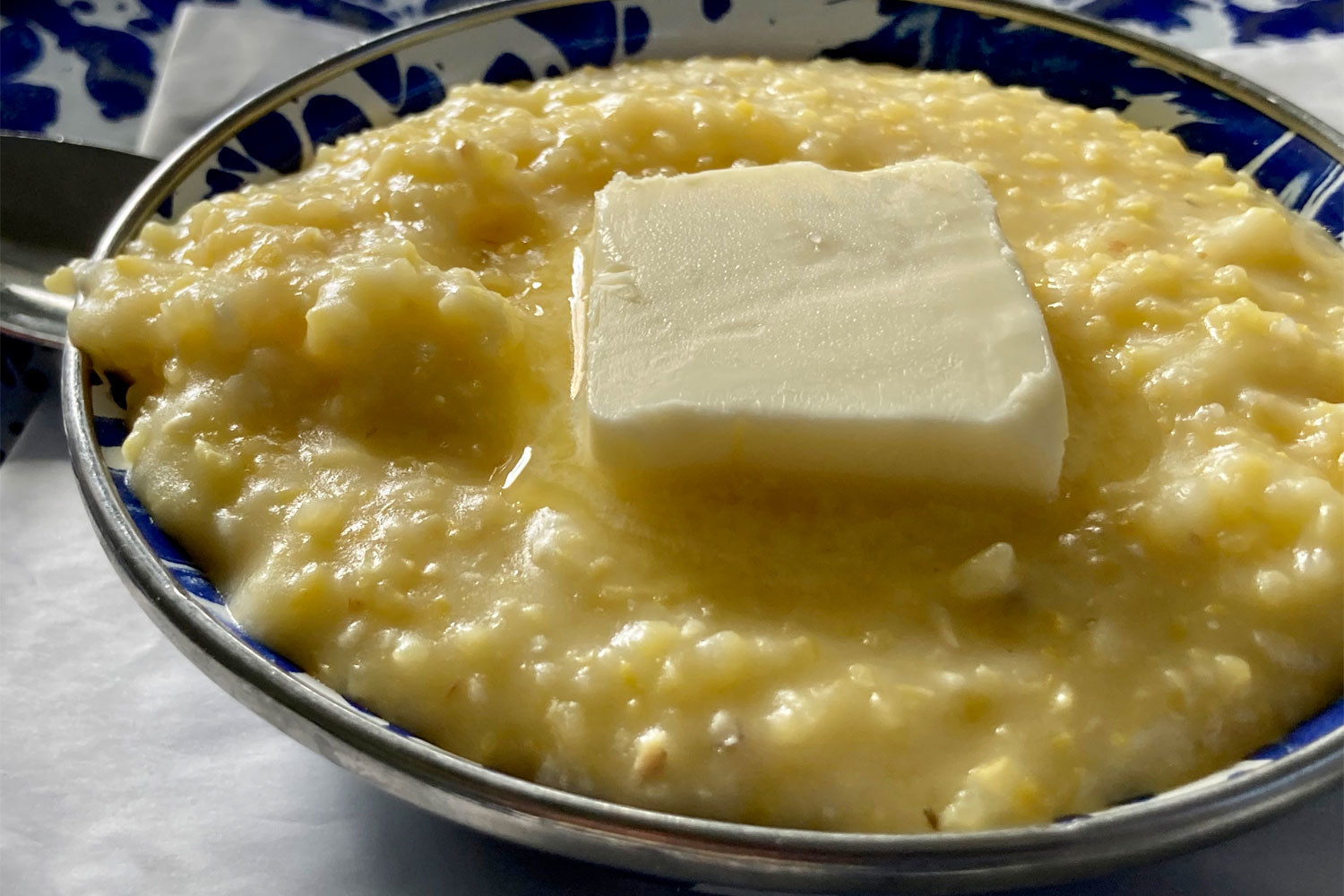 A bowl of grits with butter