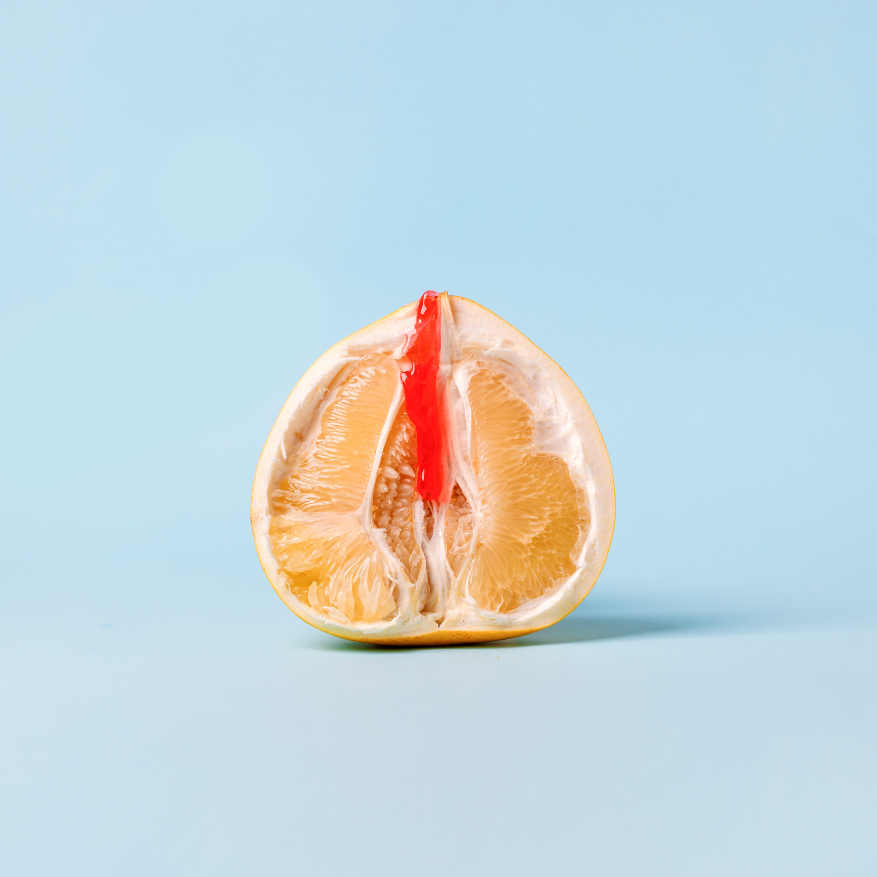 Stock image of a fruit with a red stripe depicting blood