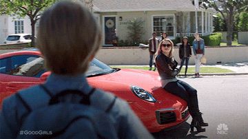 GIF of a woman sitting on a car