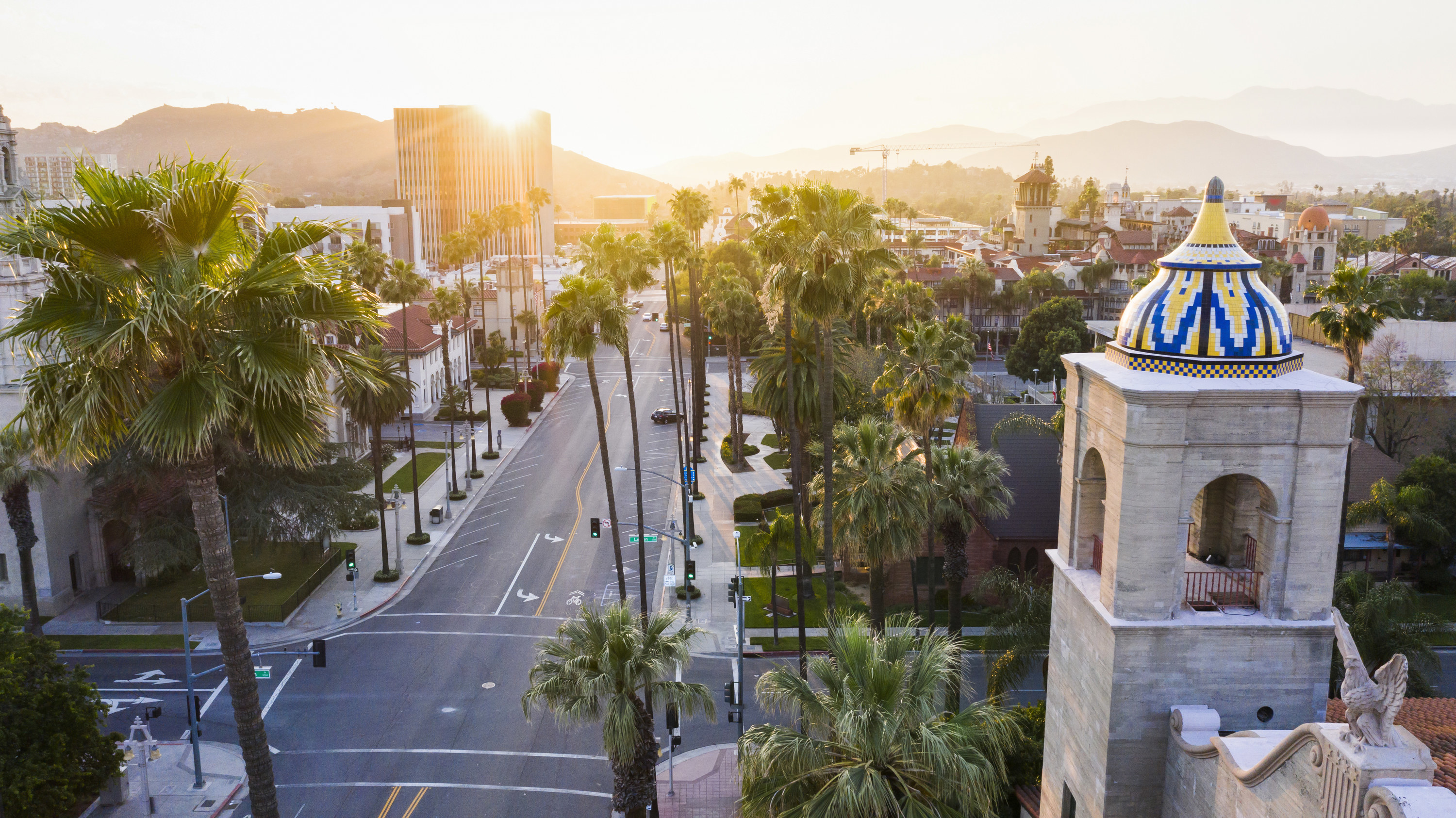 Aerial shot of a historic street lined with tall palm trees in Riverside