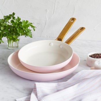 the pink 8-inch and 10-inch frying pans on a kitchen counter