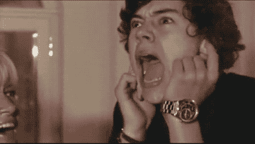 Harry Styles plugging his hears and screaming