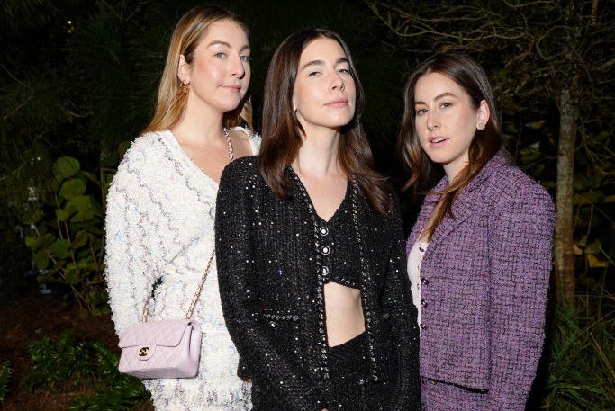 HAIM posing at a Chanel event 