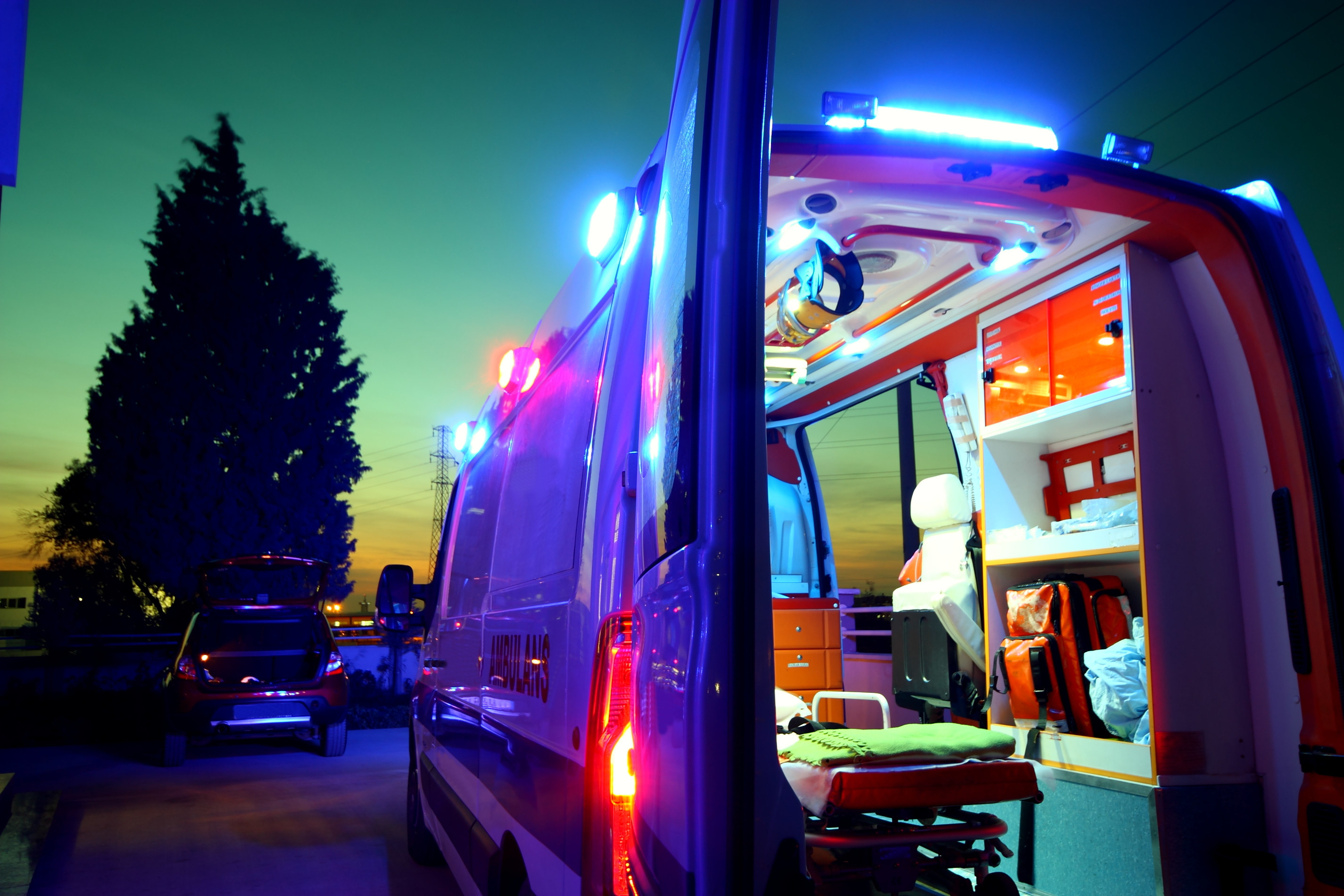 A stock image of a parked ambulance with its back doors open