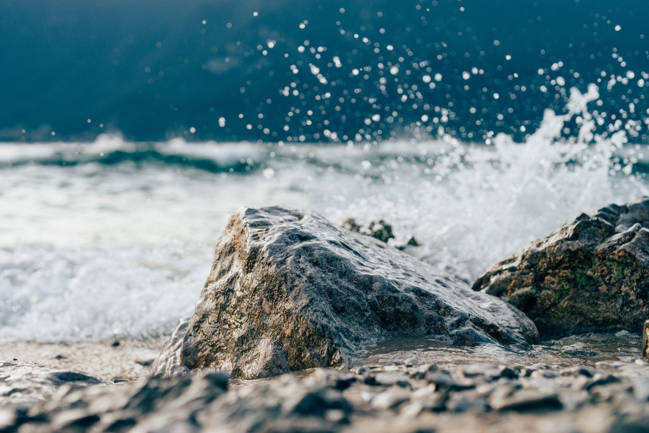 A stock image of waves splashing against rocks