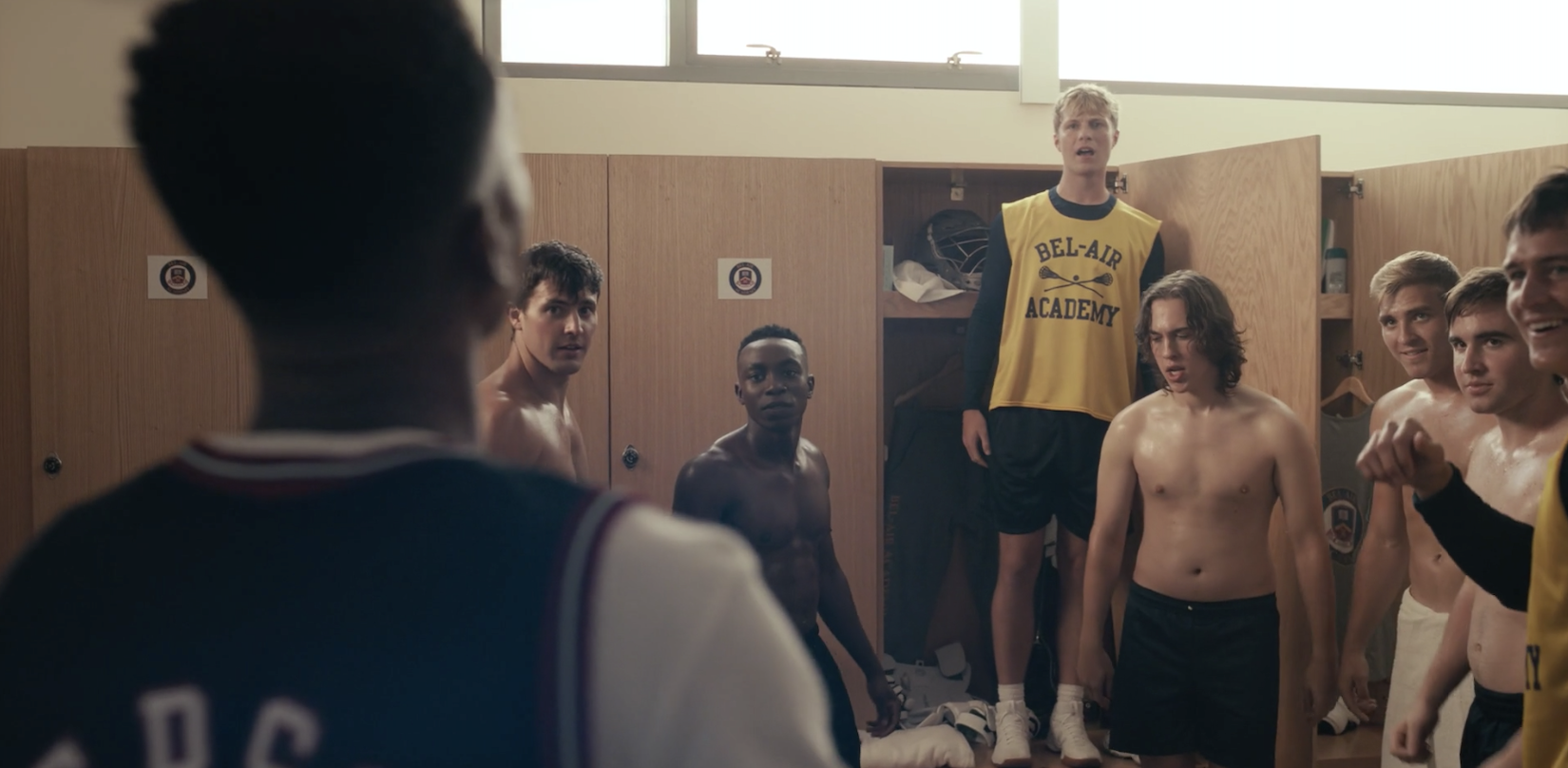Jabari Banks looking at his white classmates, and Olly Sholotan as Carlton Banks in the school lockerroom