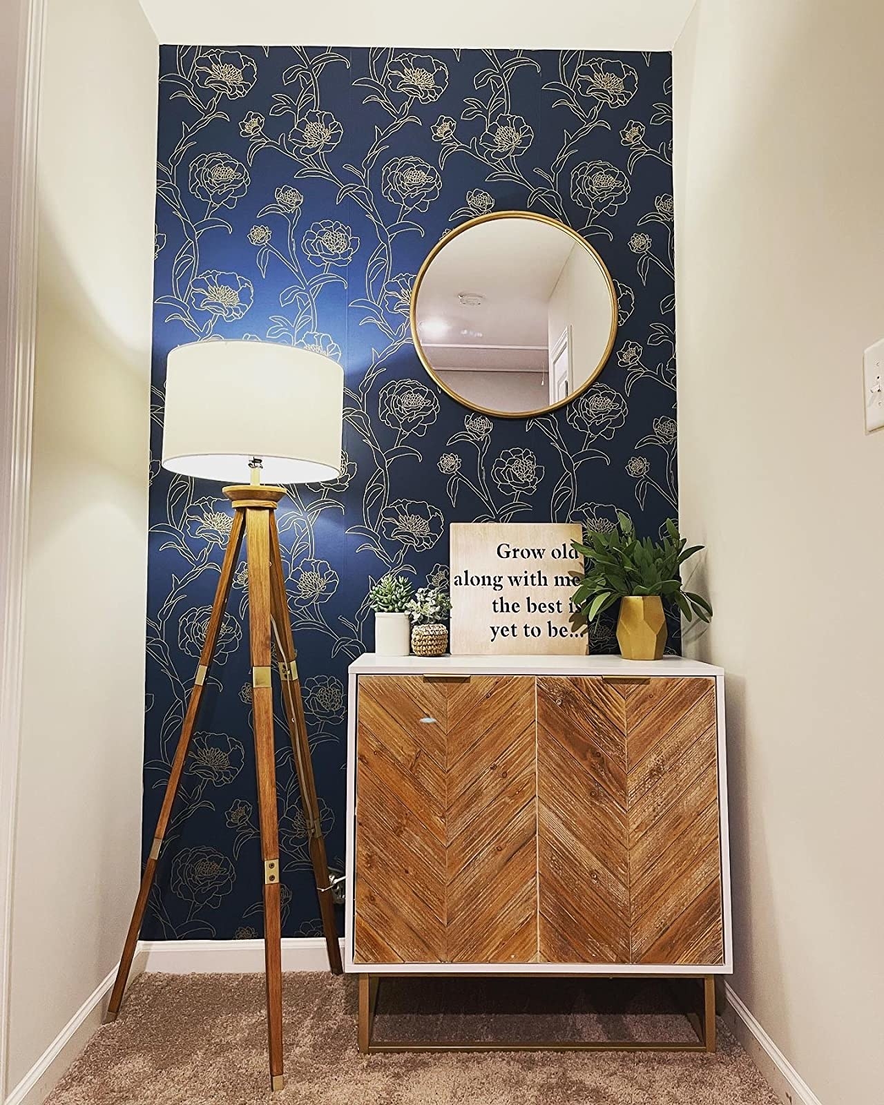 Reviewer photo of the wallpaper on a wall in front of a console table and lamp