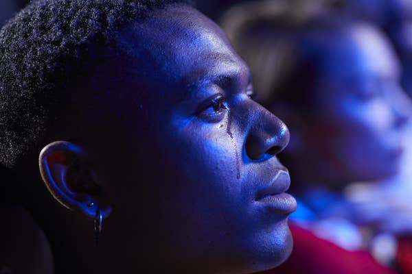 Close up of man crying while watching movie