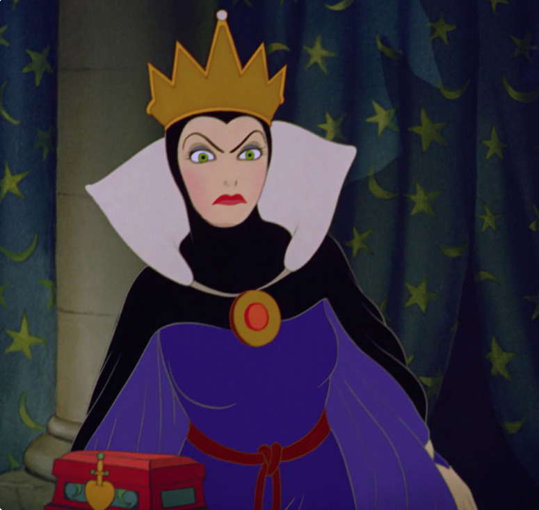 A close up of the evil queen as she holds a small box in her hands