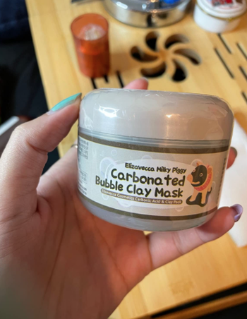 reviewer holding mask container