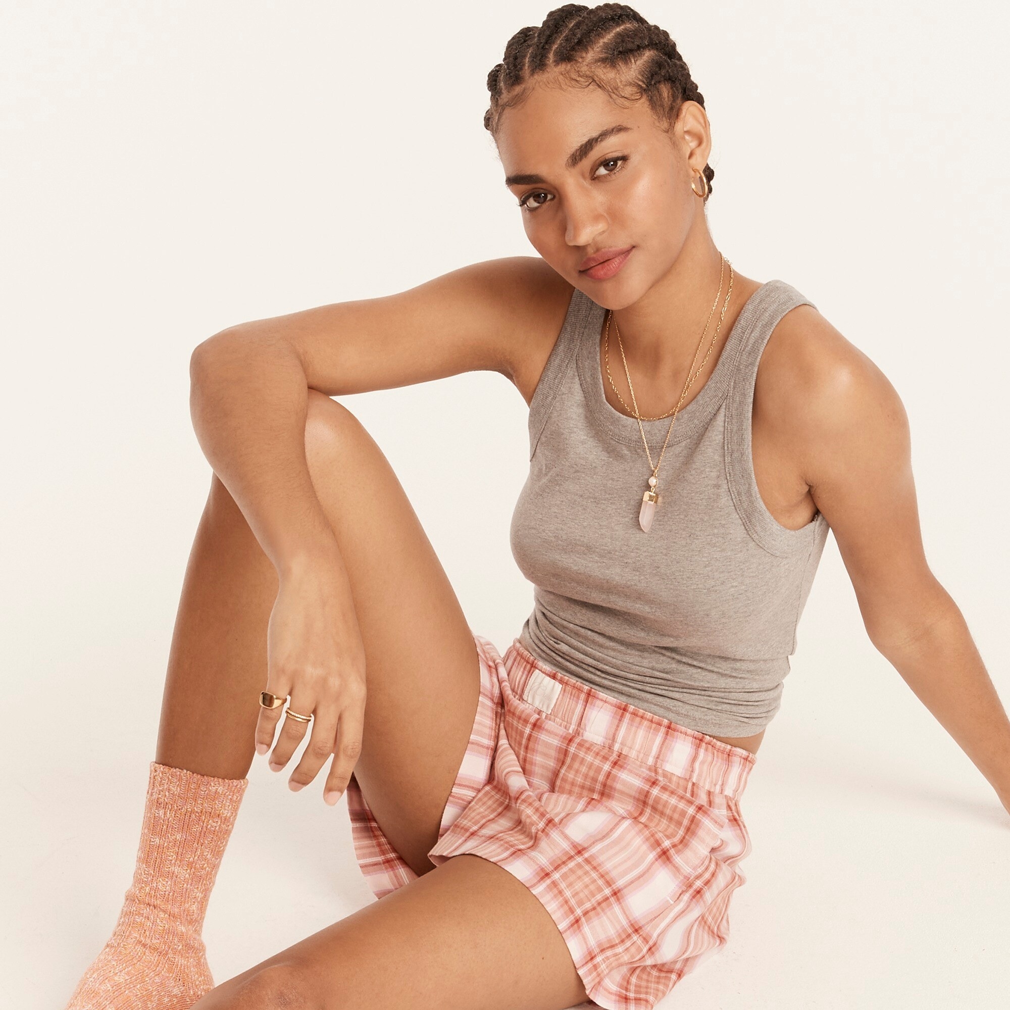 An image of a model wearing a  two-piece flannel boxer pajama set