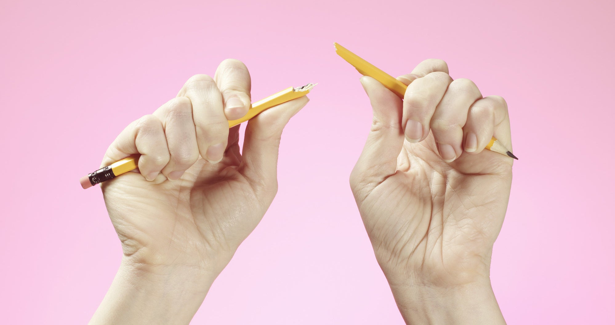 Hands holding broken pencil