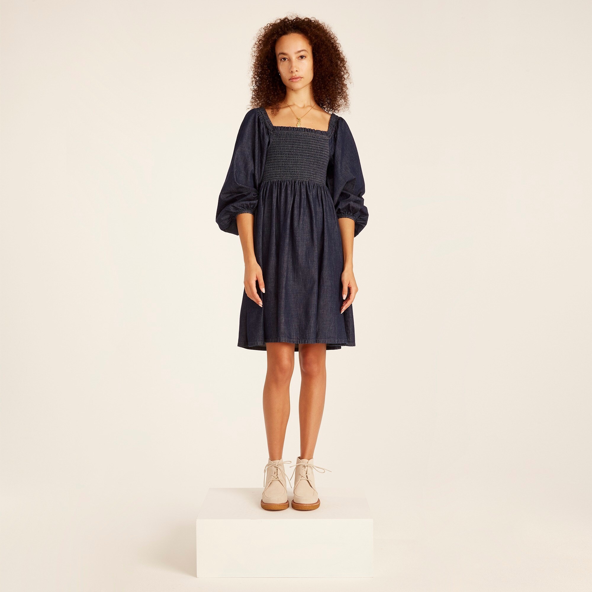 An image of a model wearing a puff-sleeve dress made from cotton materials