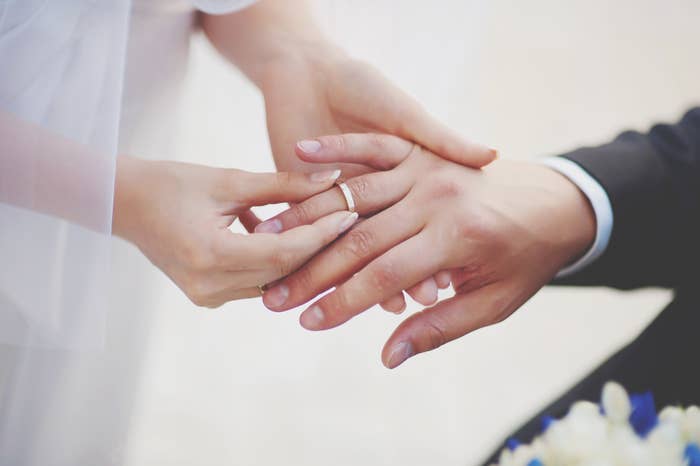 A couple exchange wedding rings on their wedding day