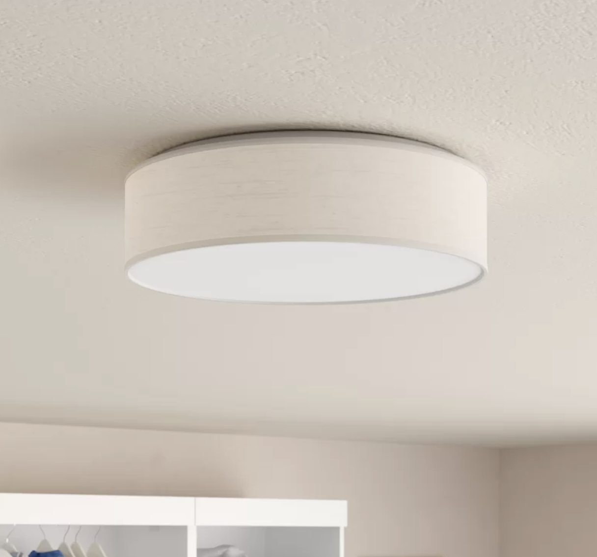 A short round white lighting fixture mounted to a ceiling