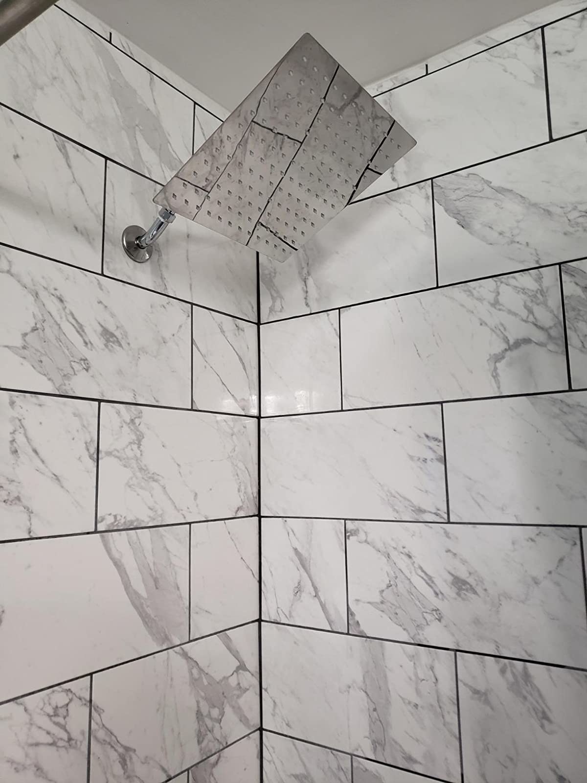 Reviewer photo of the square shower head installed in their bathroom