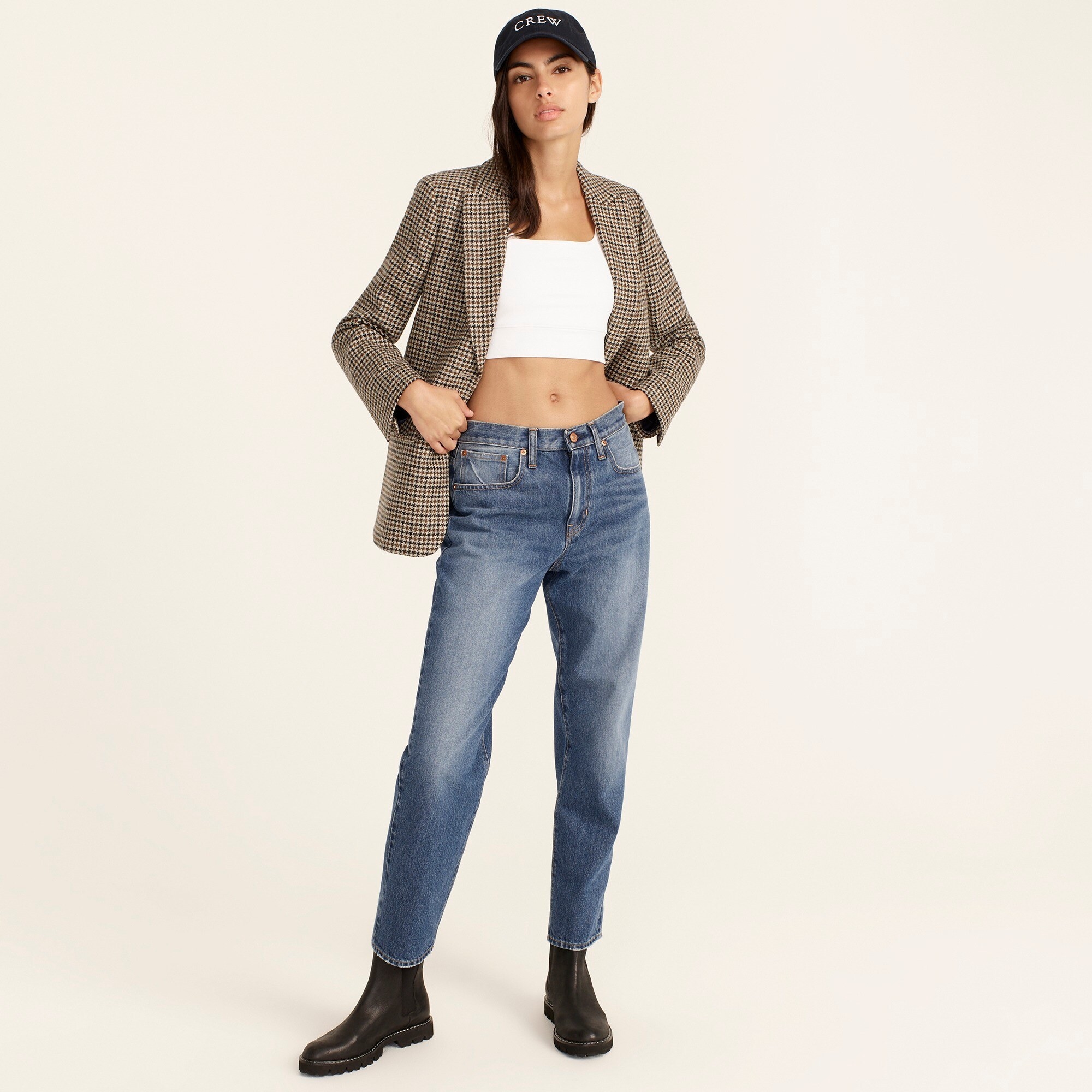 An image of a model wearing a pair of boyfriend jeans in a bright indigo wash