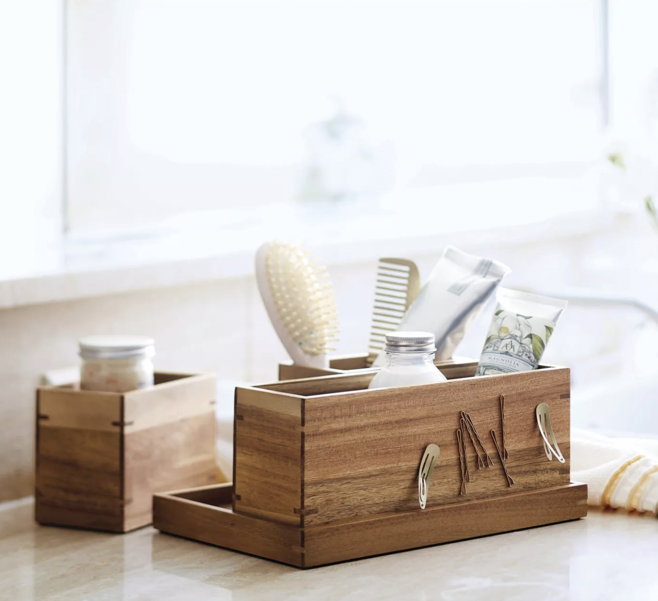 the wooden organizer holding brushes, lotion bottles, and bobby pins