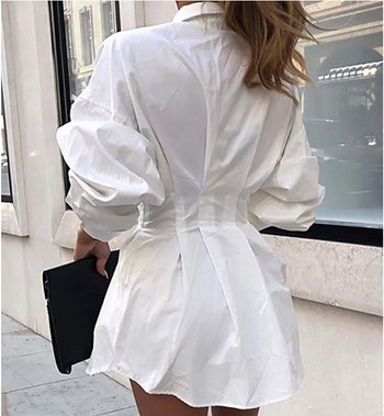 A model showing the back of the shirt dress