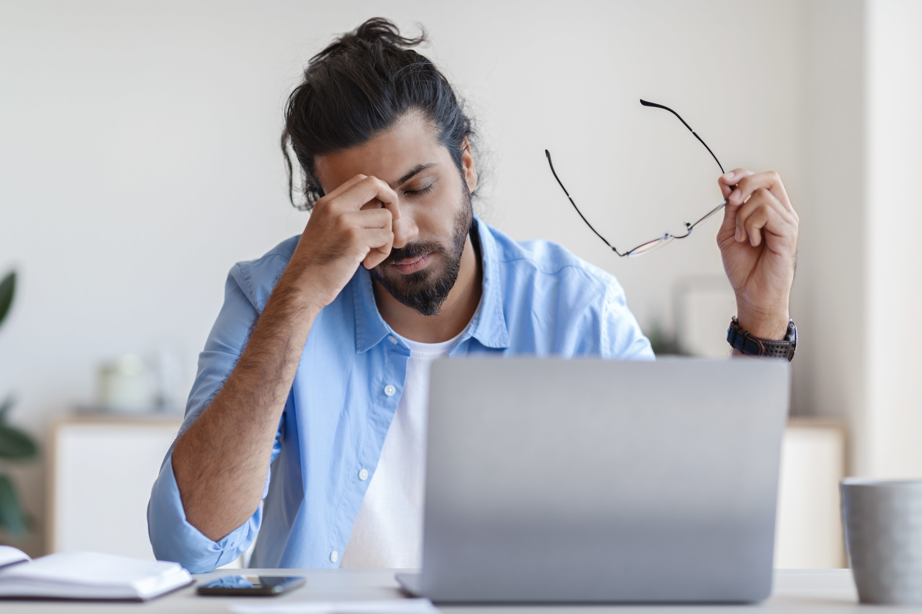 Man feeling stressed at his desk