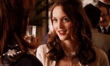 Blair smiling with a drink in her hand