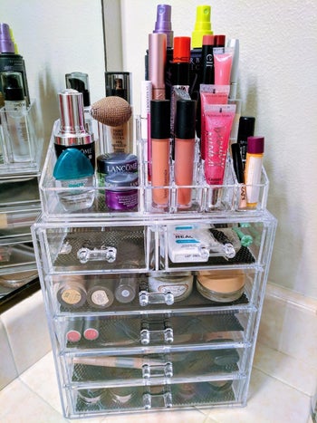 a reviewer's organizer filled with makeup and perfume