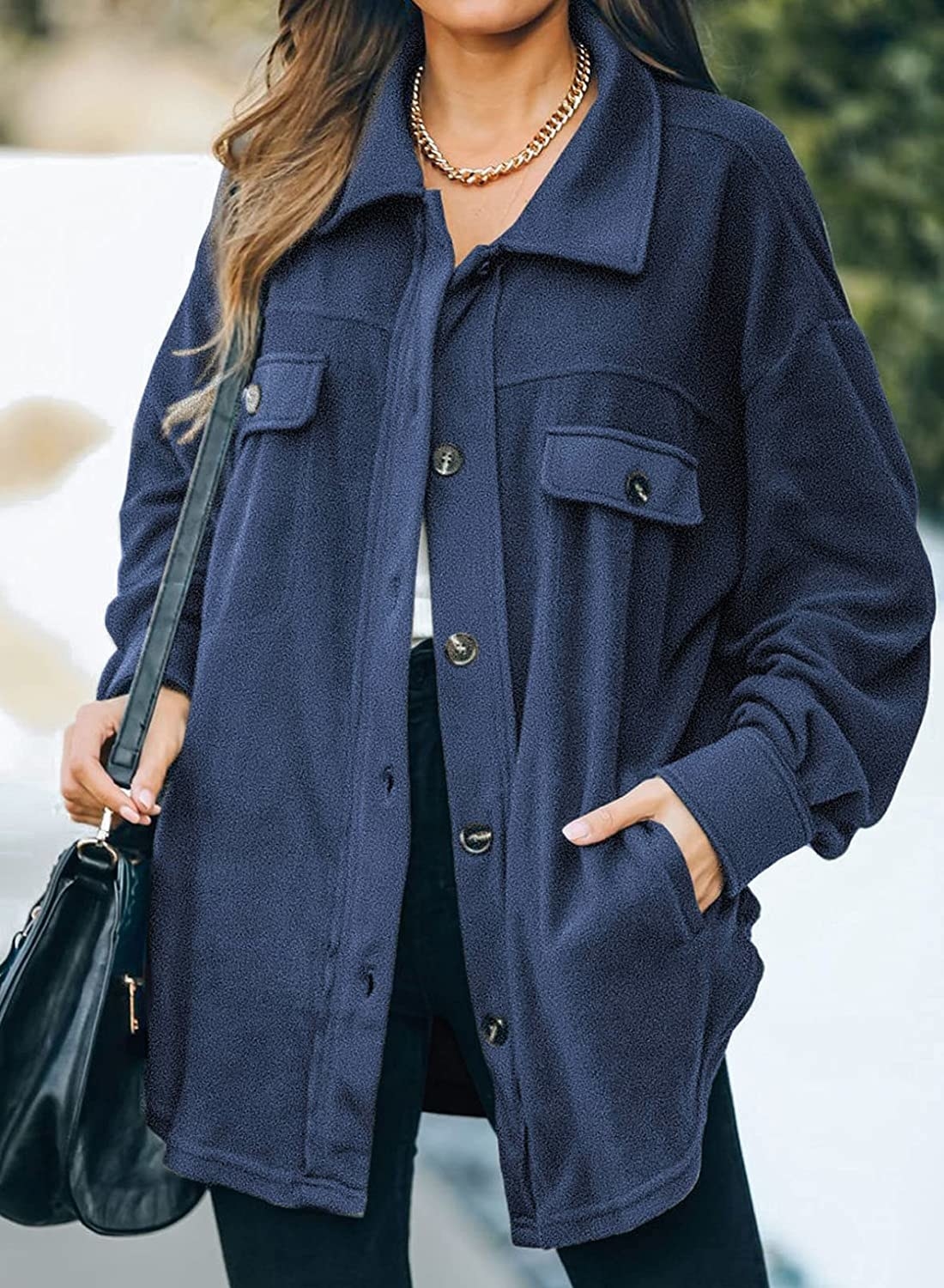 A model wearing the button-down shirt jacket with chest and waist pockets in navy blue