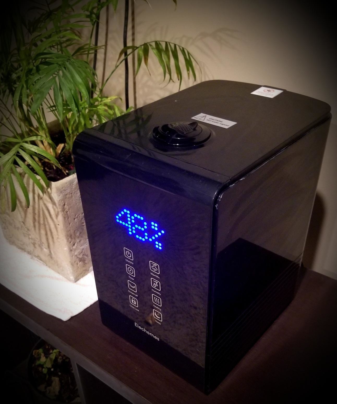 reviewer image of the black humidifier on a wooden table