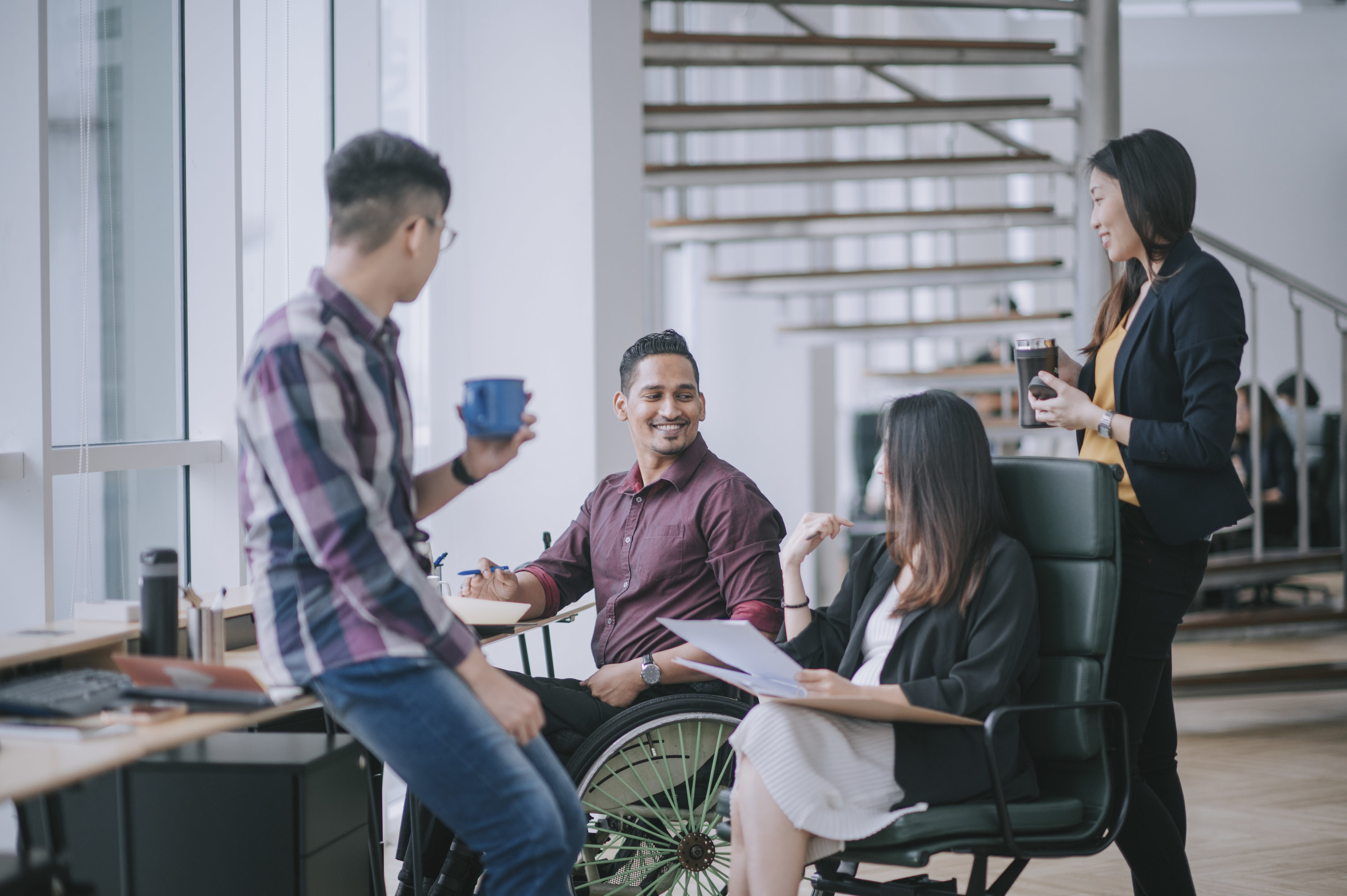 Coworkers chatting in an office