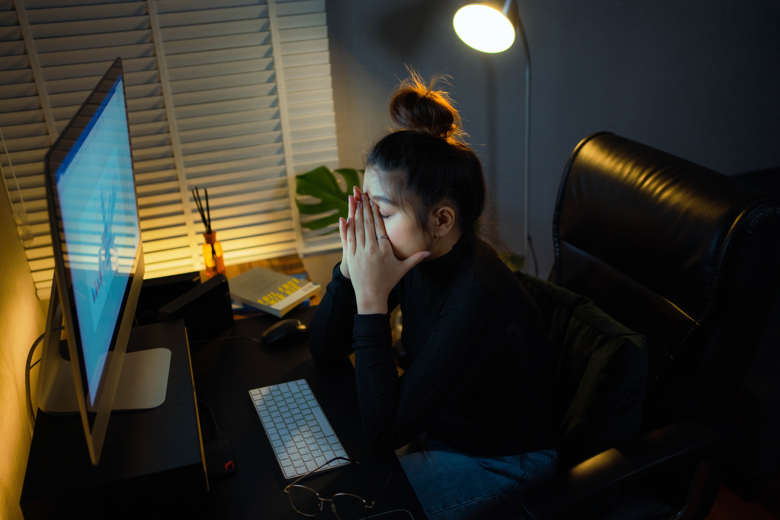 Burned out woman working from home late into the night