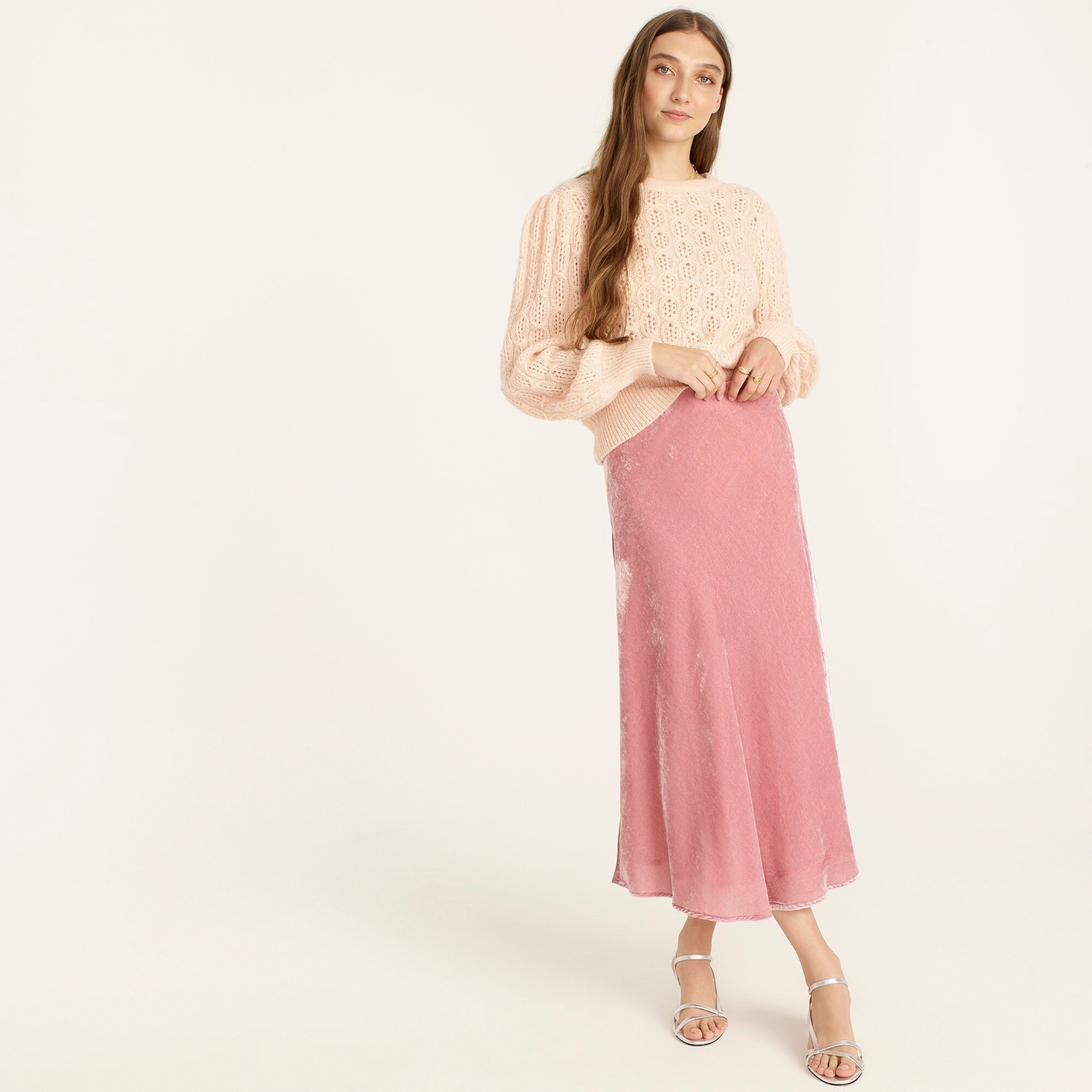 An image of a model wearing a pink pull-on velvet slip skirt