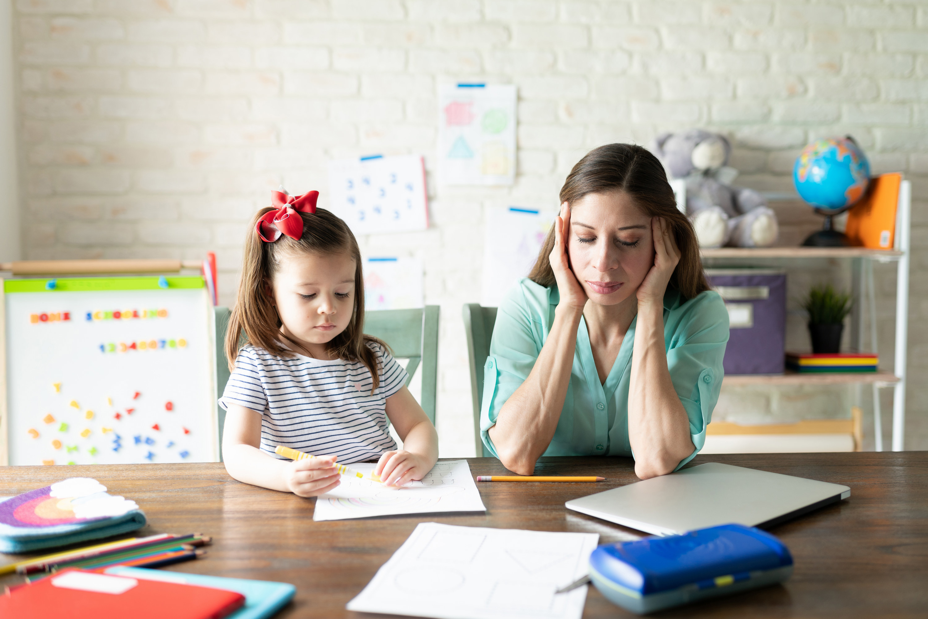 Elementary school teacher feeling stressed while trying to help a child