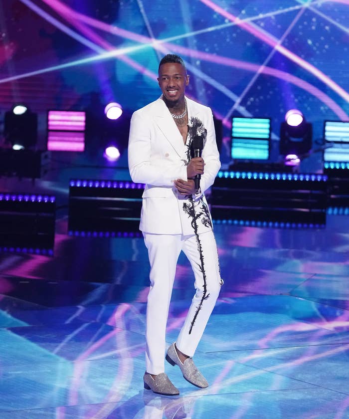 Nick Cannon stands on stage while hosting &quot;The Masked Singer&quot;