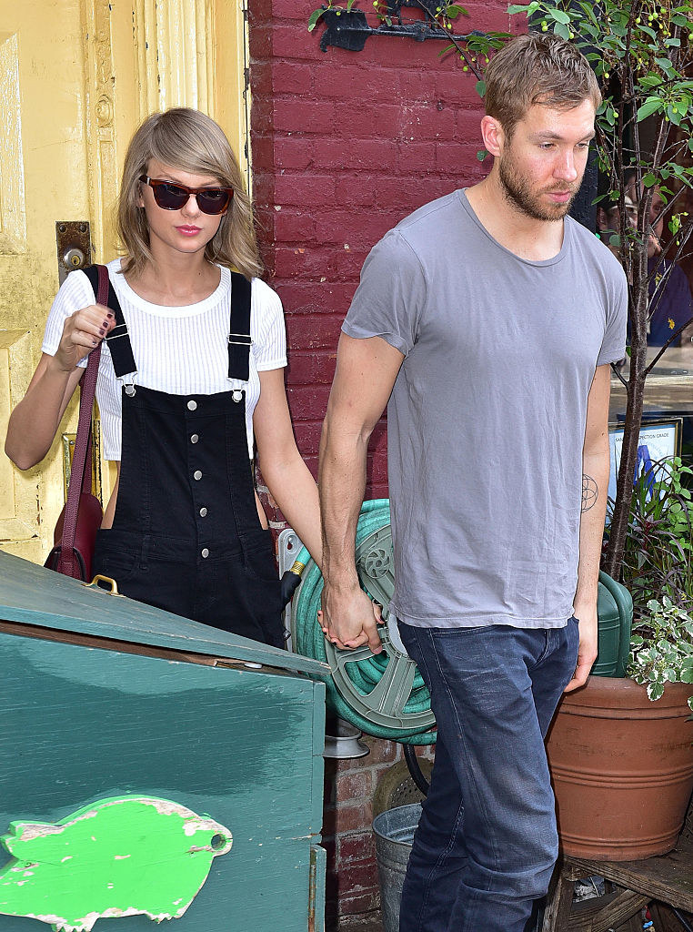 holding hands, Calvin and Taylor walk out of a restaurant