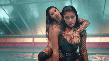 Cardi B and Megan Thee Stallion embracing in pool in &quot;WAP&quot; music video