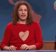 dressed in a heart sweater, Andy Samberg sobs