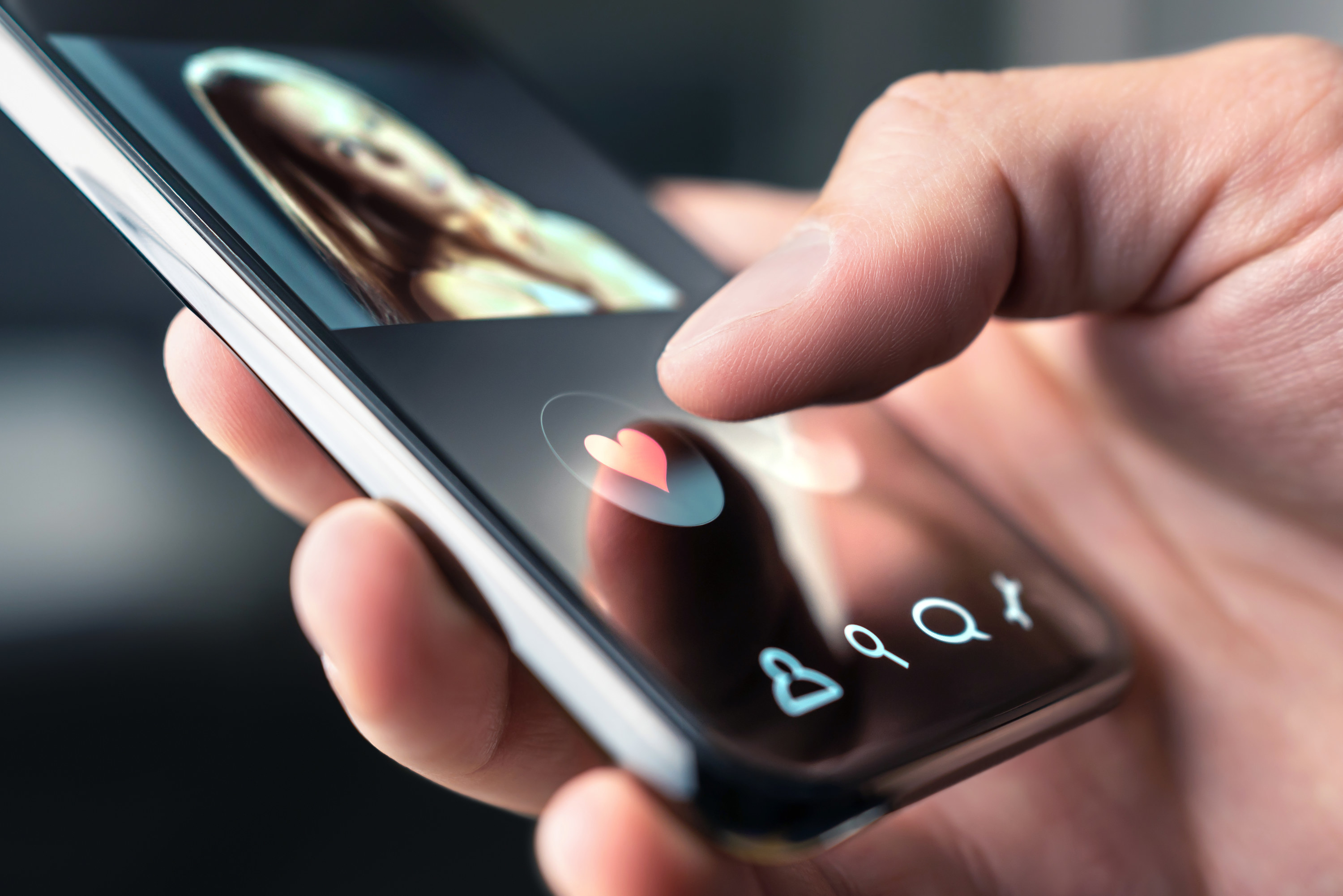 An up-close shot of a dating app opened on a smartphone