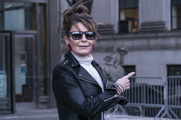 Sarah Palin is pictured wearing sunglasses and a leather jacket and pointing as she leaves court